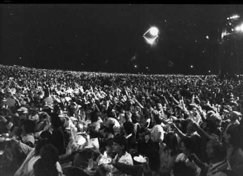 Crowds holding candles aloft at Carols by Candlelight