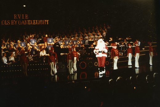Santa on stage with little drummer boys