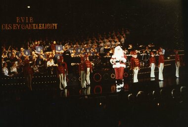 Santa on stage with little drummer boys