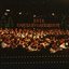 Orchestra on stage with Christmas tree lights in background