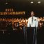 Brian Naylor at the podium with orchestra and choir behind him