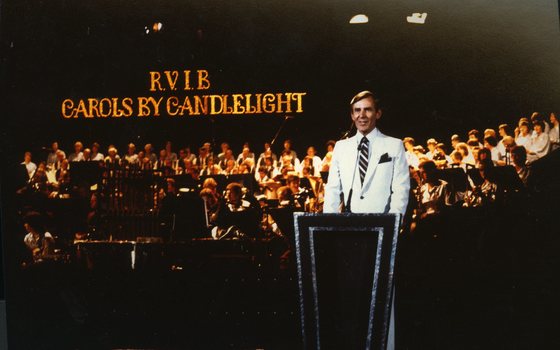 Brian Naylor at the podium with orchestra and choir behind him