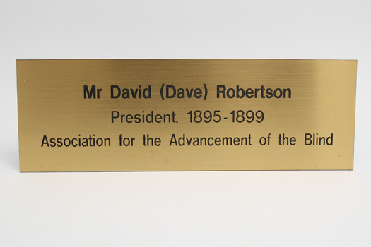 Shiny plastic rectangle with name and role in Association