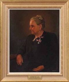 Side view of Tilly Aston in dark clothing sitting in a chair