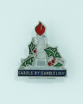 Silver coloured candle with green (holly) red (flame) and blue (CxC)