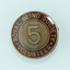 Round badge with '5' on copper background