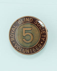 Round badge with '5' on copper background