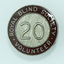 Round badges with '20' on silver cross hatched background