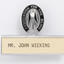 Silver and black guiding light logo with silver name plate underneath and 'Mr John Wicking'