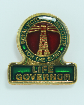 Life Governor badge - Gold lighthouse with green edging and yellow background 