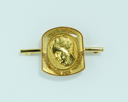 Raised image of woman with bowed head on tie pin