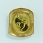 Raised image of woman with bowed head on badge