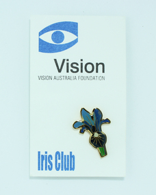 Blue iris flower in enamel attached to white cardboard