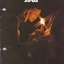 Two people with one holding a candle and the other a song book