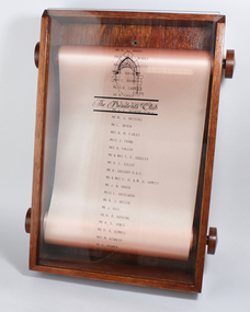 Pale pink satin printed with names loosely stretched between two wooden rods encased in a box