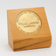 1 blonde wooden stand with gold tone inlaid medallion