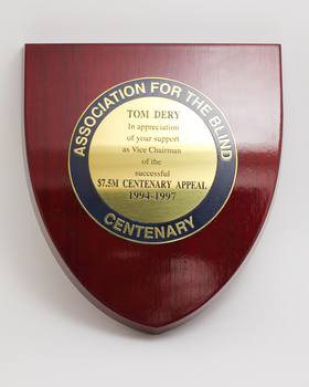 Wooden shield with plaque attached