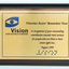 Metal plate mounted on board with blue and black writing