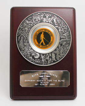 Engraved silver plate on wooden board