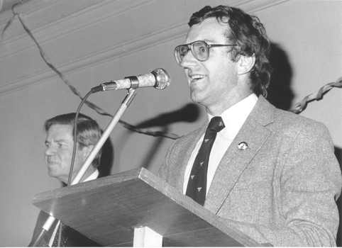 Unknown man stands at podium