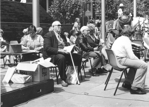 People sitting in chairs at the White Cane Day celebration