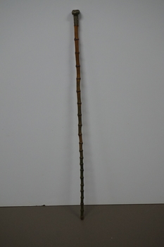 Wooden stick with ornate handle tip