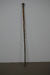 Wooden stick with ornate handle tip
