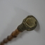 Wooden stick with ornate handle tip