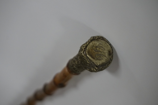 Wooden stick with ornate handle tip