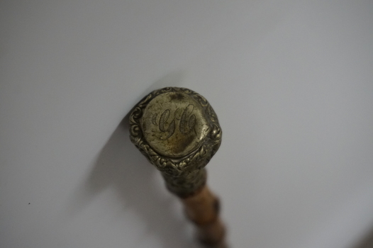 Wooden stick with ornate handle tip