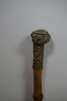 Wooden stick with ornate handle tip