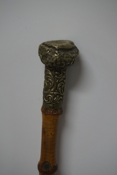 Wooden stick with ornate handle tip