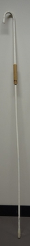 Long white cane with rubber attachment two-thirds the way up