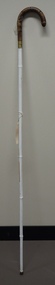 White cane with polished wooden handle and metal tip