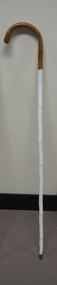 Brown handled white cane with metal tip