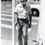 Bearded man uses white cane and sonic guide to walk over crossing