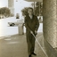 Man walks along William Street using white cane