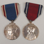 2 silver medals hanging from a red or blue ribbon with blue or red and white edging