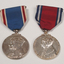 2 silver medals hanging from a red or blue ribbon with blue or red and white edging