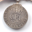 Inscription on back of medal hanging from ribbon