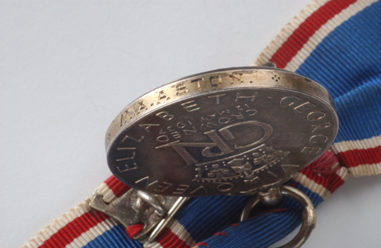 M.A. Aston inscribed on side of medal