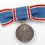 Blue ribbon tied into bow with hanging silver medal