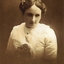 Young woman wearing white blouse and flower in her hair