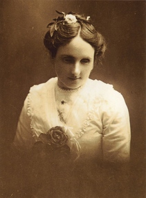 Young woman wearing white blouse and flower in her hair
