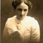 Young woman wearing white blouse and flower in her hair