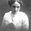 Young woman wearing white blouse and flower in her hair