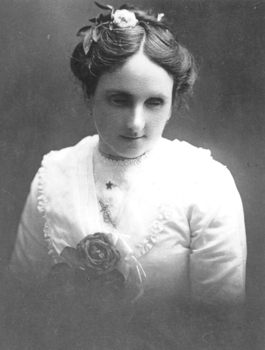 Young woman wearing white blouse and flower in her hair