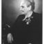 Seated older lady with two coronation medals pinned to her left breast