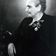 Seated older lady with two coronation medals pinned to her left breast