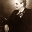 Seated older lady with two coronation medals pinned to her left breast